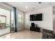 Cozy living area features a sliding door to the patio, a ceiling fan, and a TV at 4901 S Turbine --, Mesa, AZ 85212
