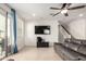 Bright living room with a sliding door to the patio and an adjacent staircase at 4901 S Turbine --, Mesa, AZ 85212