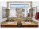 Elegant bathroom features dual sinks with granite countertops, modern fixtures, and stone accent wall at 4976 S Sugarberry Ln, Gilbert, AZ 85298