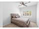 Bedroom features a ceiling fan, plush carpet, and a window at 4976 S Sugarberry Ln, Gilbert, AZ 85298