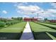 Bocce ball court featuring vibrant green turf, shaded pavilions, and clear blue skies for outdoor recreation at 4976 S Sugarberry Ln, Gilbert, AZ 85298