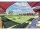 Enjoy a game of bocce ball on this beautifully maintained court with covered seating and lush landscaping at 4976 S Sugarberry Ln, Gilbert, AZ 85298