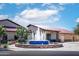 Inviting clubhouse entrance with a decorative water fountain and manicured landscaping at 4976 S Sugarberry Ln, Gilbert, AZ 85298