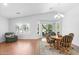 Bright and airy living space with hardwood floors, inviting seating, and large windows with backyard views at 4976 S Sugarberry Ln, Gilbert, AZ 85298