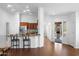 Open-concept living area with hardwood floors, bar seating and a bright, airy atmosphere at 4976 S Sugarberry Ln, Gilbert, AZ 85298