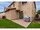 A backyard featuring artificial turf, a brick patio, and a stucco exterior home at 5253 E Hilton Ave, Mesa, AZ 85206