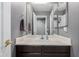 Bathroom with a large mirror, vanity sink, brown cabinets, and grey walls at 5253 E Hilton Ave, Mesa, AZ 85206