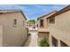 Exterior view of multi-story townhomes with stucco exteriors, tile roofs, and a community driveway at 5253 E Hilton Ave, Mesa, AZ 85206