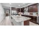 Modern kitchen featuring dark cabinets, stainless steel appliances, and a large island with granite countertops at 5253 E Hilton Ave, Mesa, AZ 85206