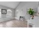 Bright living room with vaulted ceilings, wood-look flooring, and lots of natural light at 5253 E Hilton Ave, Mesa, AZ 85206