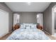 Bedroom with a large bed, neutral walls, and decorative pillows at 5253 E Hilton Ave, Mesa, AZ 85206