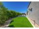 Beautifully landscaped backyard showcasing a luxurious pool and spa area, complemented by lush green artificial turf at 5515 E Dale Ln, Cave Creek, AZ 85331