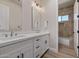 A well-lit bathroom featuring double sinks, white cabinetry, and a separate shower at 5515 E Dale Ln, Cave Creek, AZ 85331