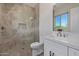Modern bathroom featuring walk-in shower with a seat, vanity, and bright natural light at 5515 E Dale Ln, Cave Creek, AZ 85331
