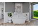 Freestanding white bathtub with accent lighting, decorative wall niche, and an adjacent window at 5515 E Dale Ln, Cave Creek, AZ 85331
