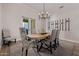 Formal dining area with a modern chandelier, wine rack, and outdoor access at 5515 E Dale Ln, Cave Creek, AZ 85331