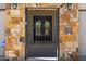 Elegant stone entryway with wrought iron gate and ornate glass door at 5515 E Dale Ln, Cave Creek, AZ 85331