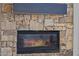 Stone fireplace with a dark mantle and visible flames at 5515 E Dale Ln, Cave Creek, AZ 85331