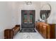 Grand foyer featuring decorative iron doors, a stylish mirror, and a decorative console table on marble floors at 5515 E Dale Ln, Cave Creek, AZ 85331