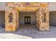 Inviting stone entryway featuring an ornate double door and decorative stone accents and tiled floors at 5515 E Dale Ln, Cave Creek, AZ 85331