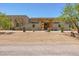 Charming desert home featuring a stone entryway and a beautifully landscaped front yard with native plants at 5515 E Dale Ln, Cave Creek, AZ 85331