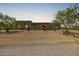 Stunning desert home featuring a landscaped front yard with native trees and stonework accents on the facade at 5515 E Dale Ln, Cave Creek, AZ 85331