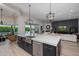 Open-concept kitchen with island seating, modern fixtures, and views of the pool at 5515 E Dale Ln, Cave Creek, AZ 85331