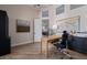 Home office with modern wooden desk, world map, stylish decor, and view through open door at 5515 E Dale Ln, Cave Creek, AZ 85331