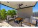 Covered outdoor lounge features comfortable seating, modern fan, and views of green privacy hedge at 5515 E Dale Ln, Cave Creek, AZ 85331