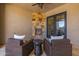 Cozy outdoor patio area with a stone fireplace, comfortable seating, and sliding glass doors for indoor-outdoor living at 5515 E Dale Ln, Cave Creek, AZ 85331