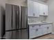 Pantry featuring stainless steel refrigerator, white cabinets and drawers, and granite countertops at 5515 E Dale Ln, Cave Creek, AZ 85331