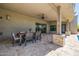 Covered patio features an outdoor dining table with seating, a ceiling fan, and stone accents at 5515 E Dale Ln, Cave Creek, AZ 85331