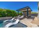 Stunning pool area with lounge chairs, cabana, and lush landscaping, perfect for entertaining and relaxation at 5515 E Dale Ln, Cave Creek, AZ 85331