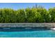 Sparkling pool features a stone waterfall and lush greenery backdrop for a private oasis at 5515 E Dale Ln, Cave Creek, AZ 85331