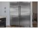 Stainless steel refrigerator complementing the white cabinetry and kitchen design at 5515 E Dale Ln, Cave Creek, AZ 85331