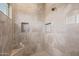 A spacious shower area with beige tile, including a rainfall shower head and built in shampoo niche at 5515 E Dale Ln, Cave Creek, AZ 85331