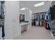A luxurious walk-in closet featuring custom shelving, drawers, mirrors and a dressing table at 5515 E Dale Ln, Cave Creek, AZ 85331