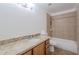 Bathroom featuring a vanity with granite countertop and a tiled shower-tub combo at 556 N Hobson Plz, Mesa, AZ 85203