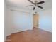 Bedroom with closet featuring ceiling fan and a closet with sliding doors at 556 N Hobson Plz, Mesa, AZ 85203