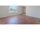 Bedroom featuring hardwood floors and natural light from a grid window at 556 N Hobson Plz, Mesa, AZ 85203