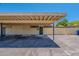 The front entrance to the house with parking spaces under the carport at 556 N Hobson Plz, Mesa, AZ 85203