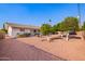 View of home's backyard showcasing trees, gravel landscaping, an extended patio, and the home's exterior at 5633 E Colby St, Mesa, AZ 85205