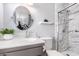 Charming bathroom with a modern vessel sink, round mirror, quartz counters and glass shower enclosure at 5633 E Colby St, Mesa, AZ 85205