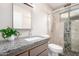 Contemporary bathroom showcasing granite countertops, modern fixtures, and elegant tiled shower at 5633 E Colby St, Mesa, AZ 85205