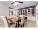 Bright dining area featuring a wooden table, upholstered chairs, and built-in display cabinets at 5633 E Colby St, Mesa, AZ 85205