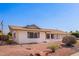 Charming single-story home featuring well-maintained landscaping and a classic design under a clear blue sky at 5633 E Colby St, Mesa, AZ 85205