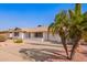 Well-maintained home featuring a front yard with mature palm trees and ample parking on a paved driveway at 5633 E Colby St, Mesa, AZ 85205