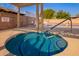 Inviting hot tub with blue tile accents, metal handrail, and views of the community pool area at 5633 E Colby St, Mesa, AZ 85205