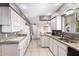 Functional kitchen with white cabinets, granite counters, and ample natural light at 5633 E Colby St, Mesa, AZ 85205