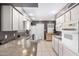 Well-lit kitchen featuring granite countertops, white cabinetry, and modern appliances at 5633 E Colby St, Mesa, AZ 85205